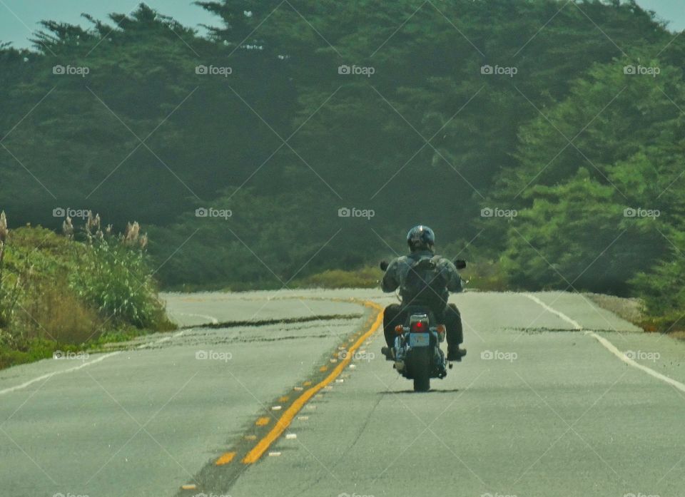 Solo Motorcycle Rider. Motorcyclist Riding Alone On A Country Road
