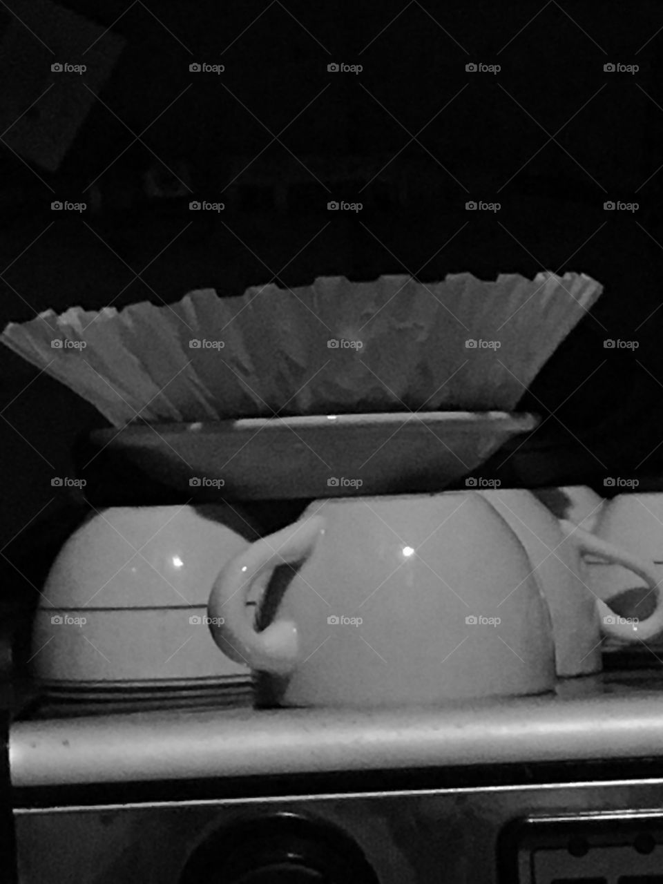 BW upside down coffee cups topped with large paper coffee filter on top of commercial espresso machine