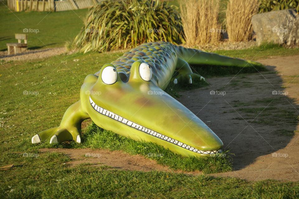 Bench with shape of crocodile in Cardiff Bay, Wales, UK