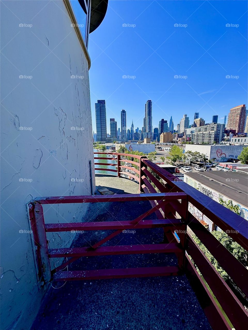 This is the outpost with watchtower of the “Pulaski Bridge” at “Newtown Creek” that connects “Greenpoint”, Bklyn to LIC, Queens. In the distance we see LIC and “Manhattan” including the “Empire State Building”. 2024. Hypnotic Productions