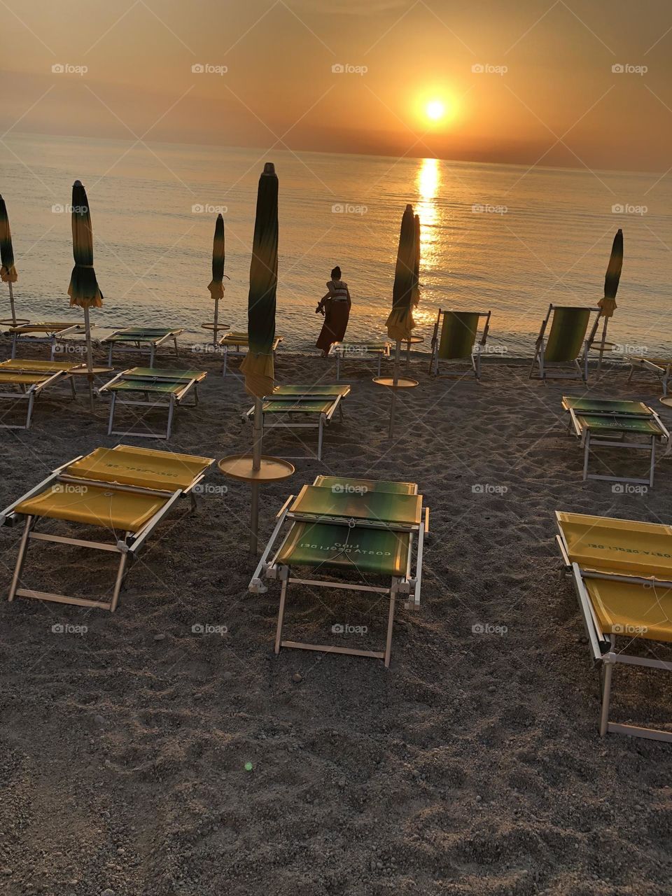 Beach in Tropea, Calabria, Italy at sunset; sunset on the beach; sunset on the sea; 