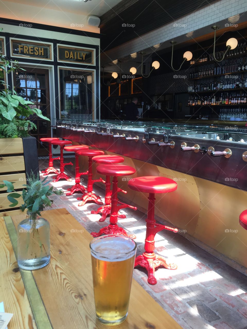 Beer, hops, bar and cast iron red chairs
