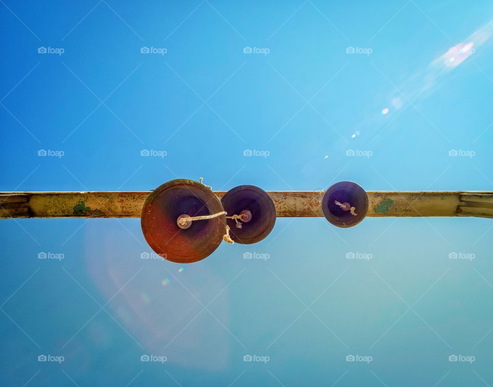 3 Bells hanging on blue sky background in Georgia 