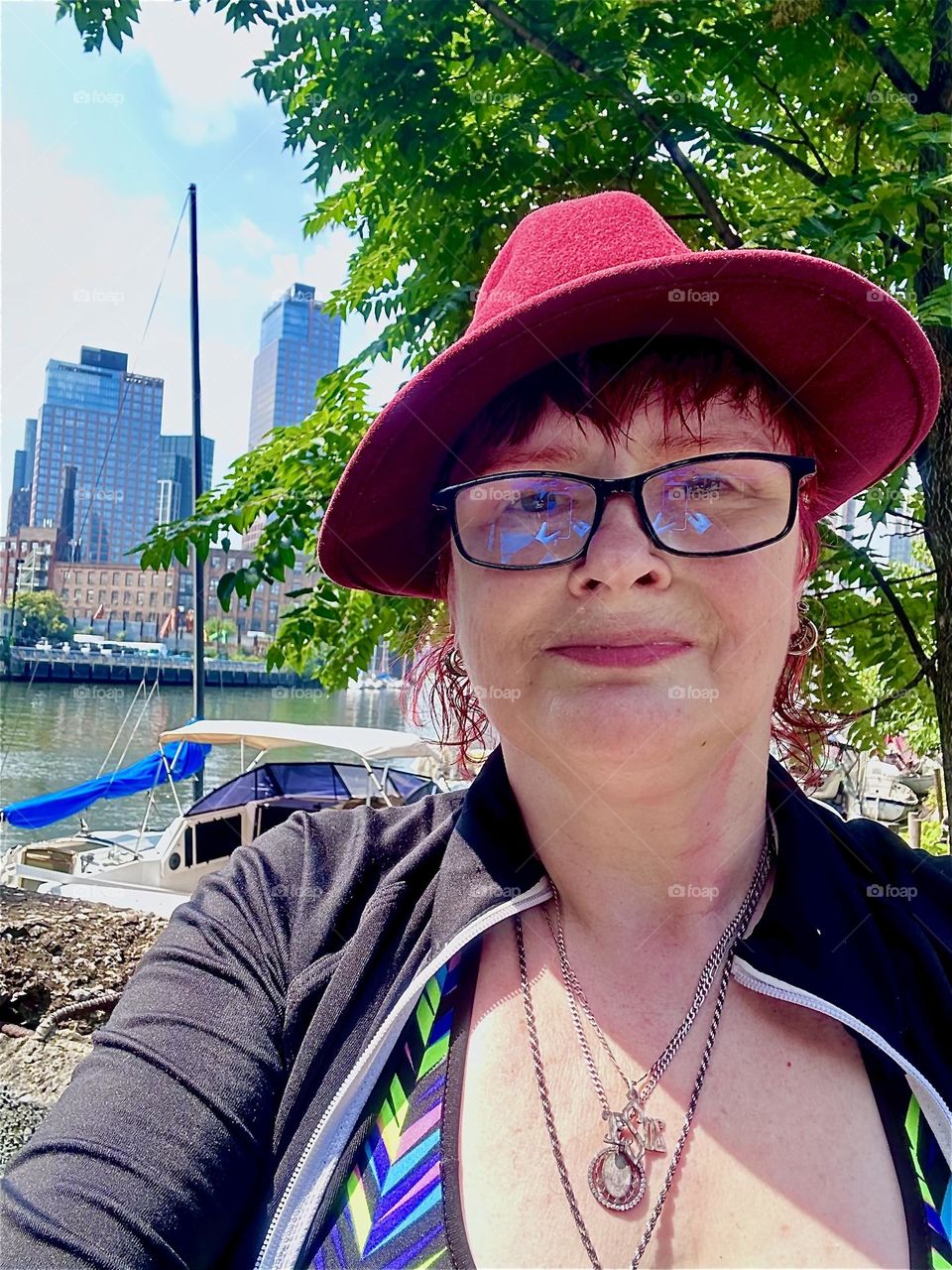 On the way back to “Salvation”, a “28 ft 1969 Luhrs” cabin cruiser at “Newtown Creek” in LIC, Queens I, “Petra Schiller” a.k.a. “Maxine Firefox” stop for a photo opportunity in the parking lot beneath the “Pulaski Bridge”. 2024. Hypnotic Productions