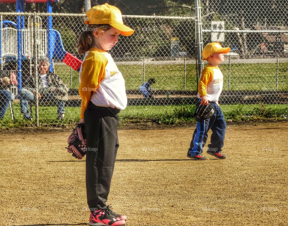 Young Boy And Girl Playing Baseball