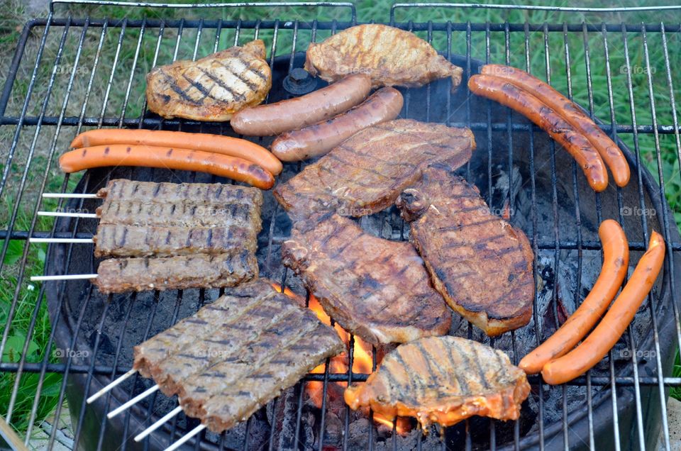 Meat and sausages on barbecue