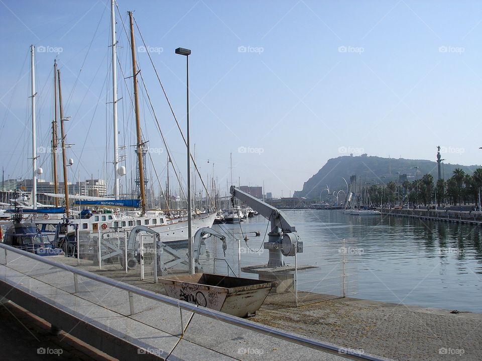 Harbor in Barcelona with yachts and sailing ships