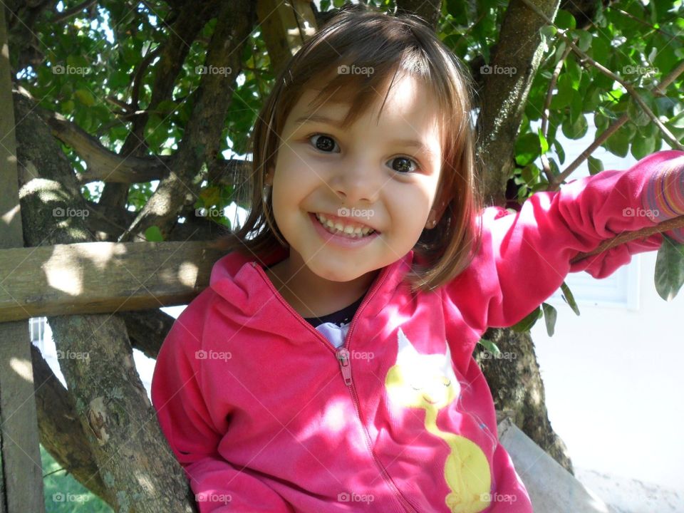smiling girl on the tree