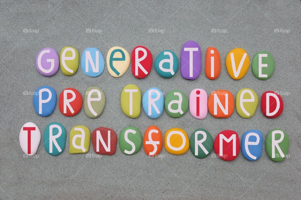 GPT, Generative pre trained transformer, artificial intelligence model composed with multi colored stone letters over green sand