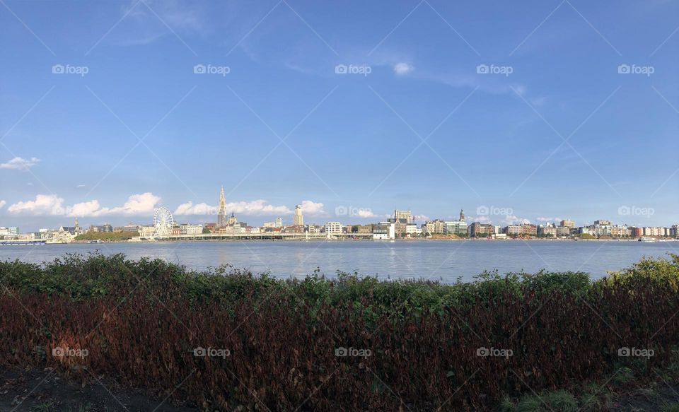 City landscape from the other side of the river and a blue sky