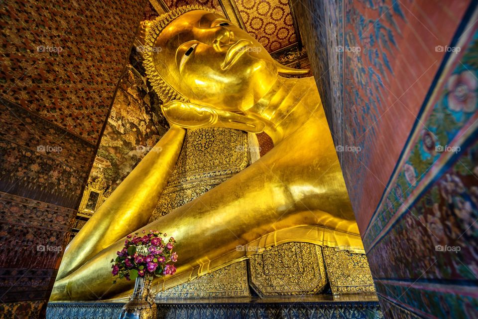 Reclining Buddha, the posture of a sleeping or reclining lion. The figure is 15 meters high and 46 meters long, and it is one of the largest Buddha statues in Thailand.