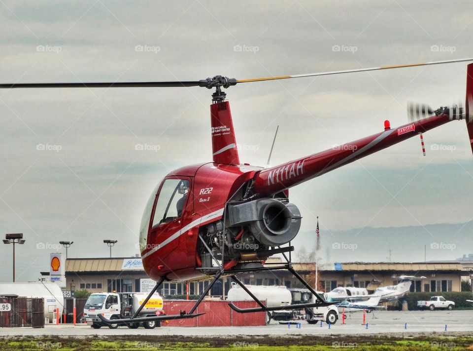 Hovering Helicopter. Robinson R-22 Helicopter Hovering Over An Airfield