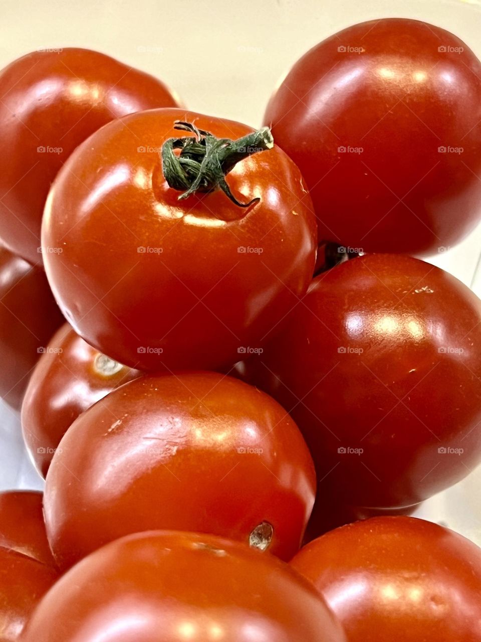 Cherry tomatoes are bright red. Shot close-up. 