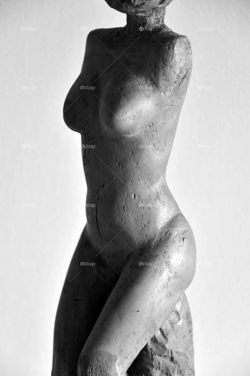 naked body of a woman, wood carving