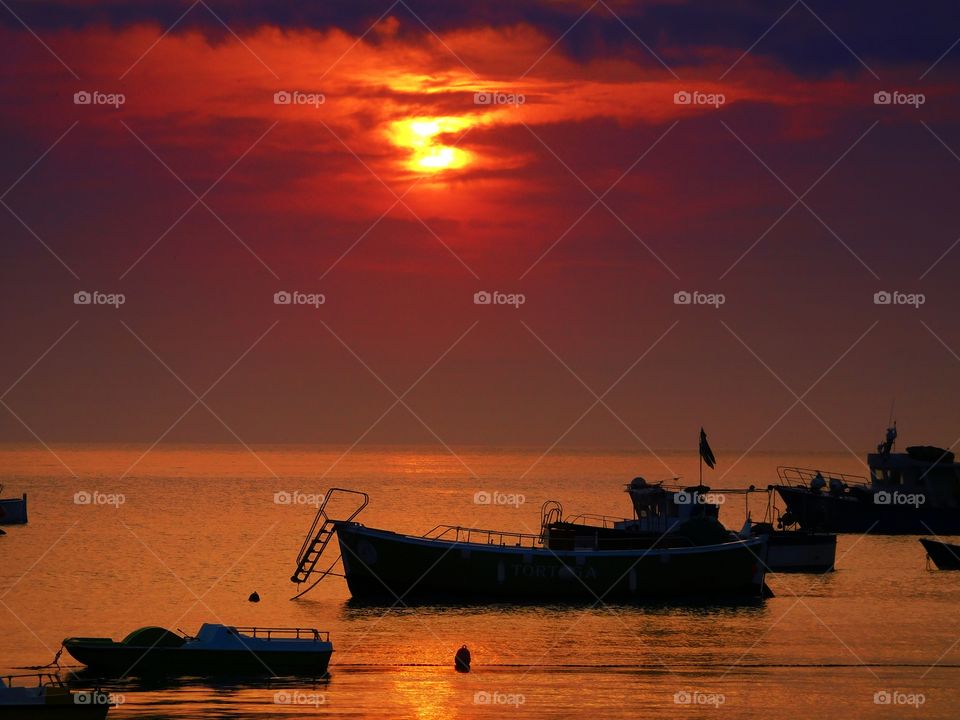 Sunset over the boats (Praia - Italy ).