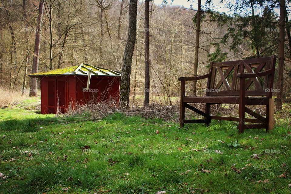 Park Bench and red hut