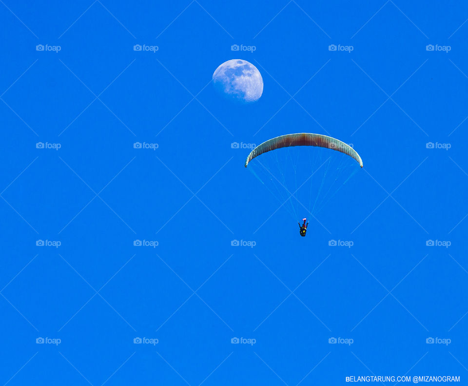 Paraglider with the moon