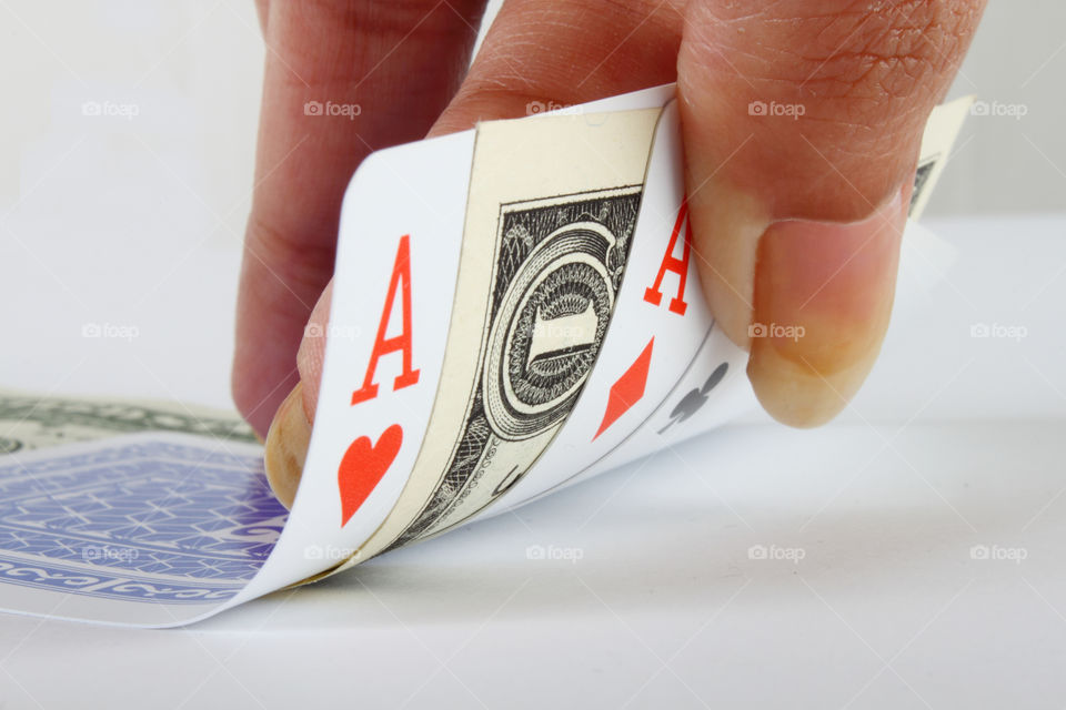 Playing cards with a dollar in between, gambling game concept