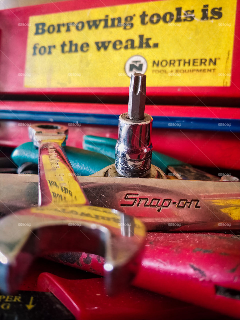 Tools in red and blue toolbox. Grungy. Borrowing tools is for the weak. wrenches