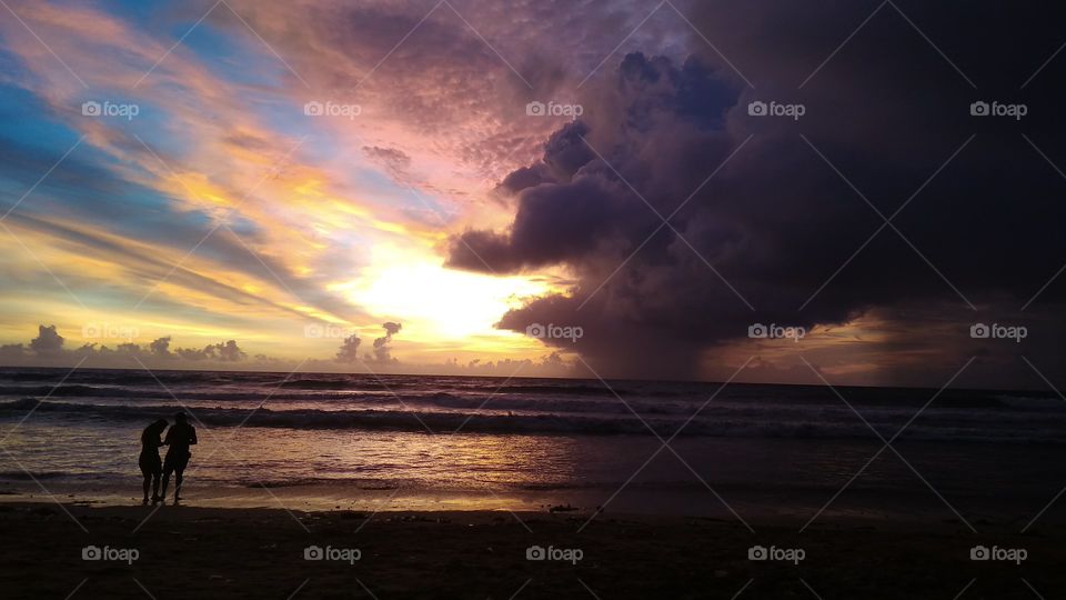 when enjoying the sunset on the beach of Kuta, Bali, Indonesia