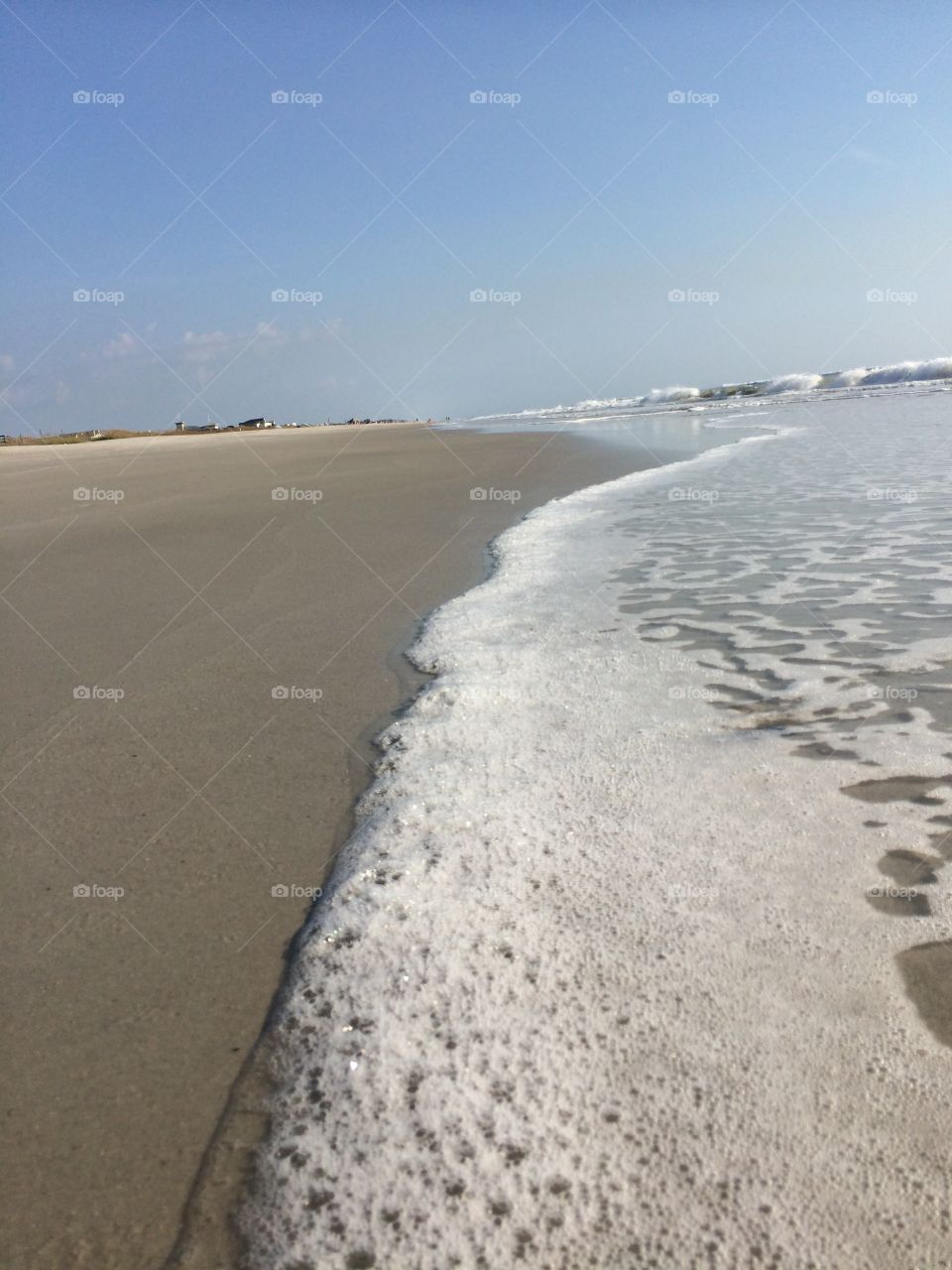 Empty beach sea foam on sand. 