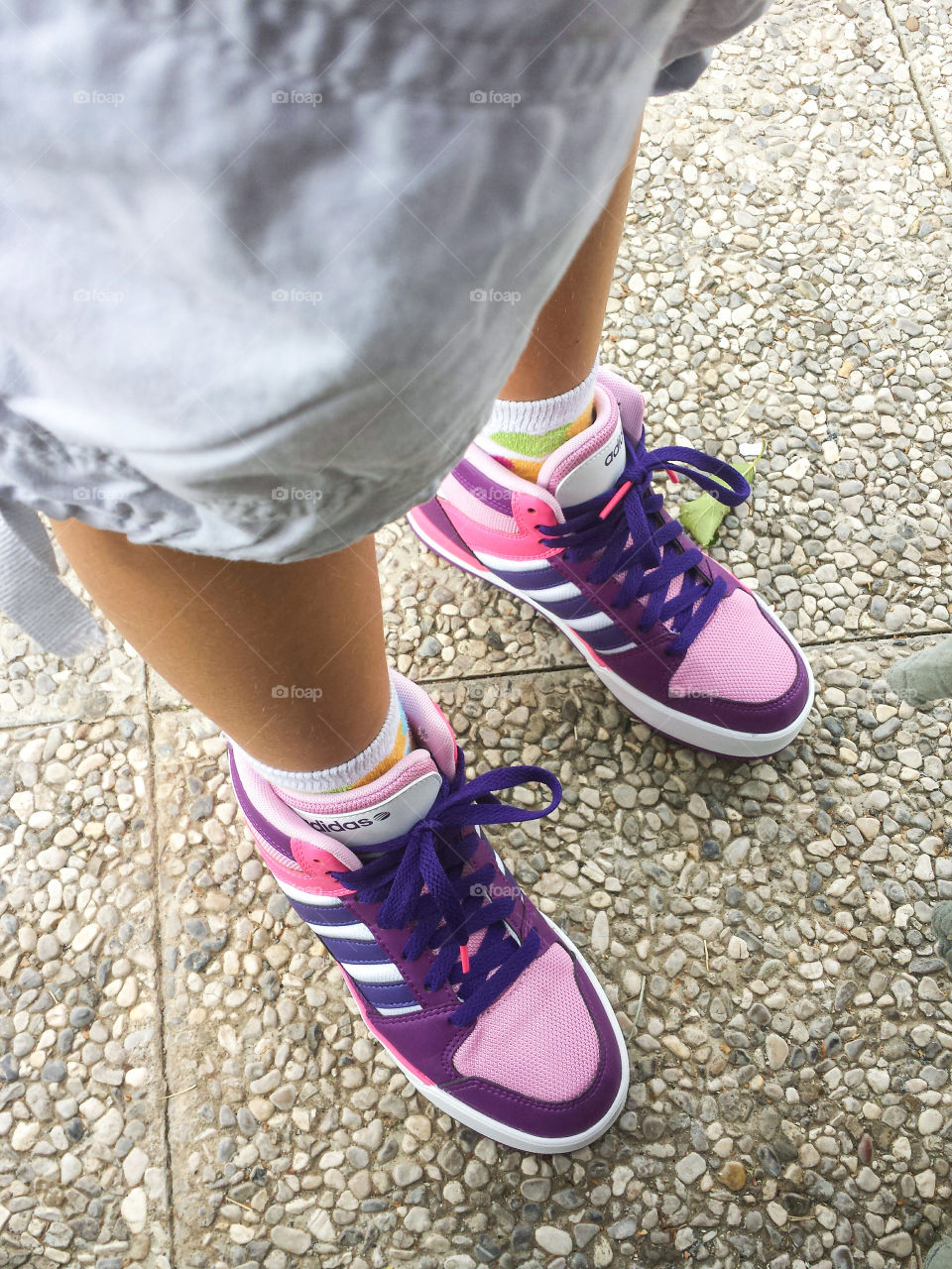 a little girl with purple shoes