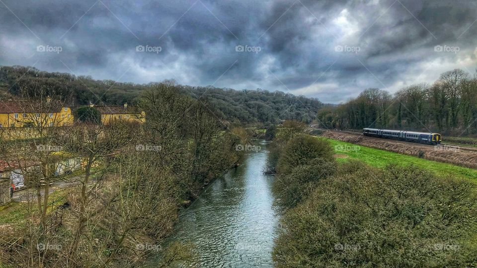 British countryside, railway and river below stormy clouds