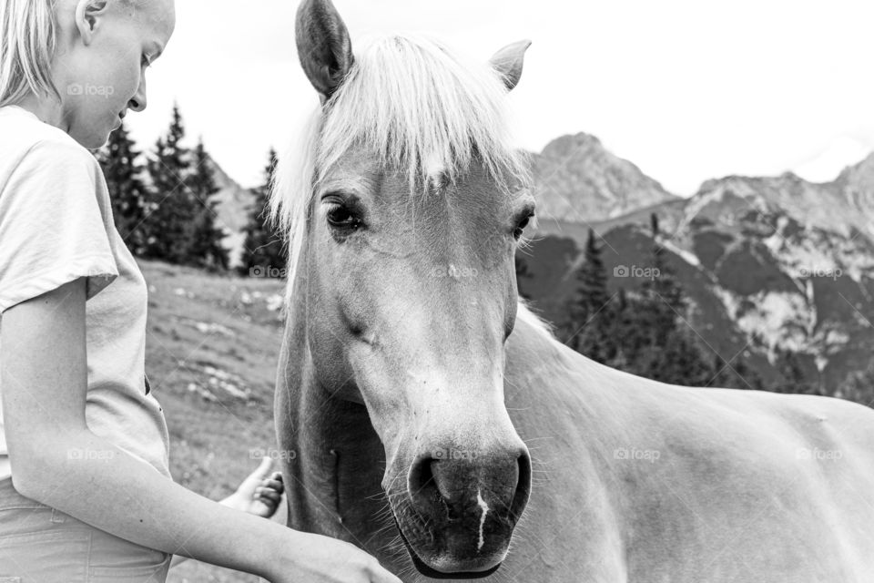 horse and a girl in the mountains - black and white
