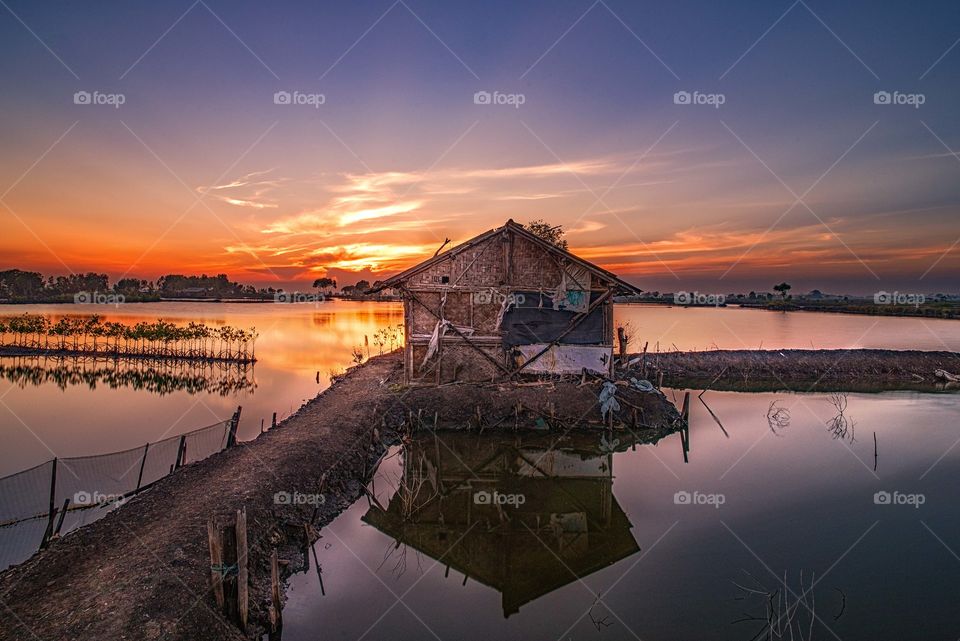 wonderful sunset, wonderful small house in the middle of field rice