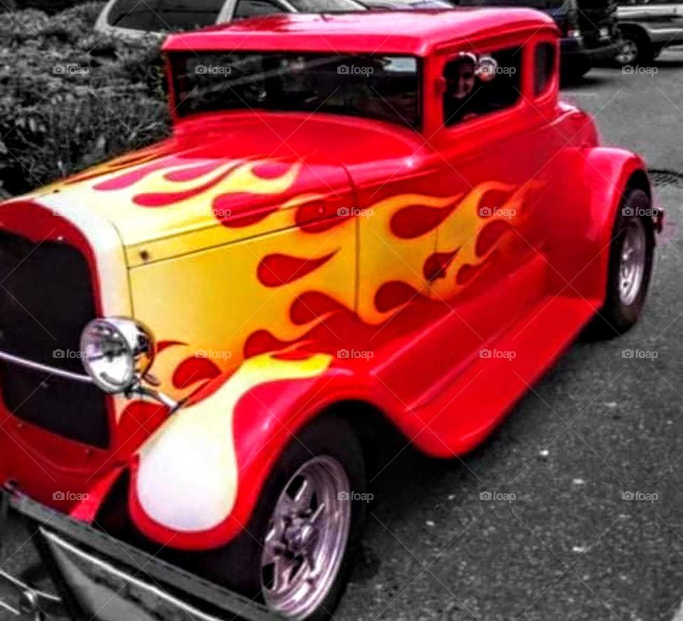 photograph of red with yellow flames hotrod