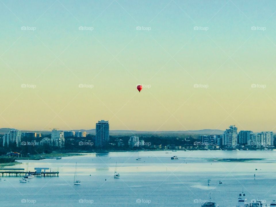 Sunrise and a balloon off on the horizon 