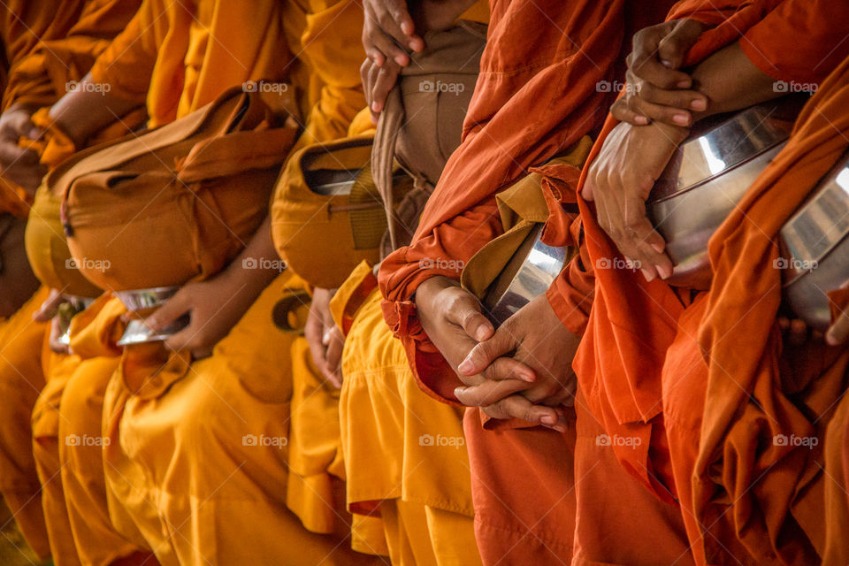 Monk in orange robes with begging bowl