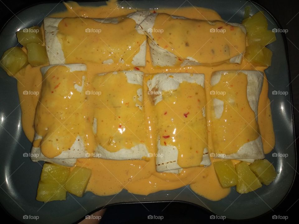 One of my awesome concoctions. Homemade enchiladas with medium queso and pineapples