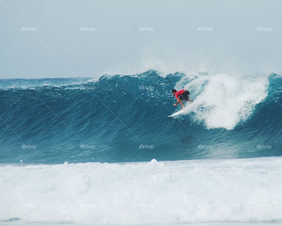 Action shot of pro surfer Flores at pipe pro on Oahu 