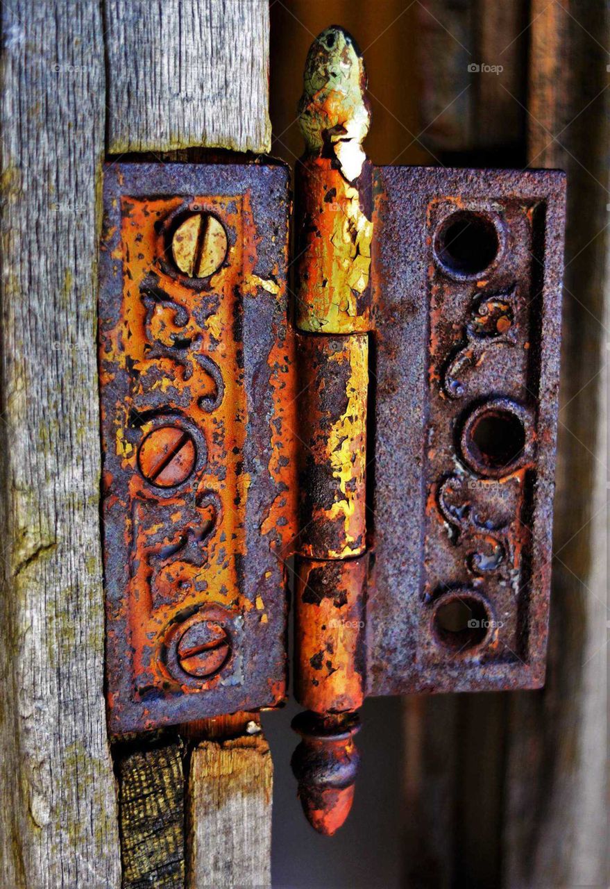 Colorful old hinge on door in Montana ghost town