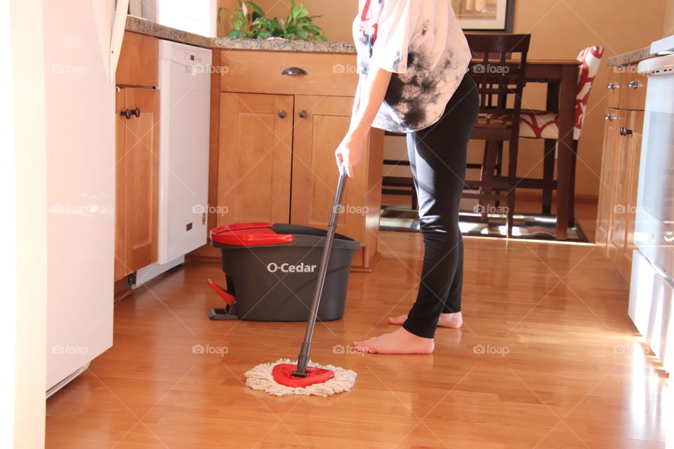 Girl using O-Cedar mop and bucket 