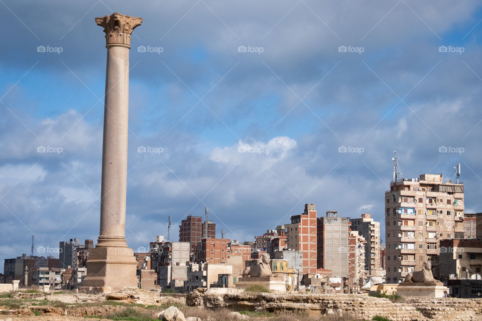 Pompeii’s Pillar in front of city scape background at Alexzandria Egypt