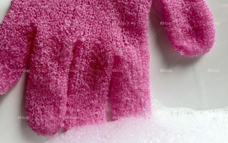 Pink wool glove in soap sud