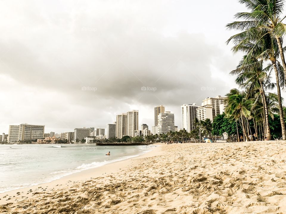 Waikiki Beach is located on the south shore of Honolulu Hawaii. the world-famous neighborhood of Waikiki was once a playground for Hawaiian royalty. High rise buildings surrounding the ocean is truly an amazing site to see. 