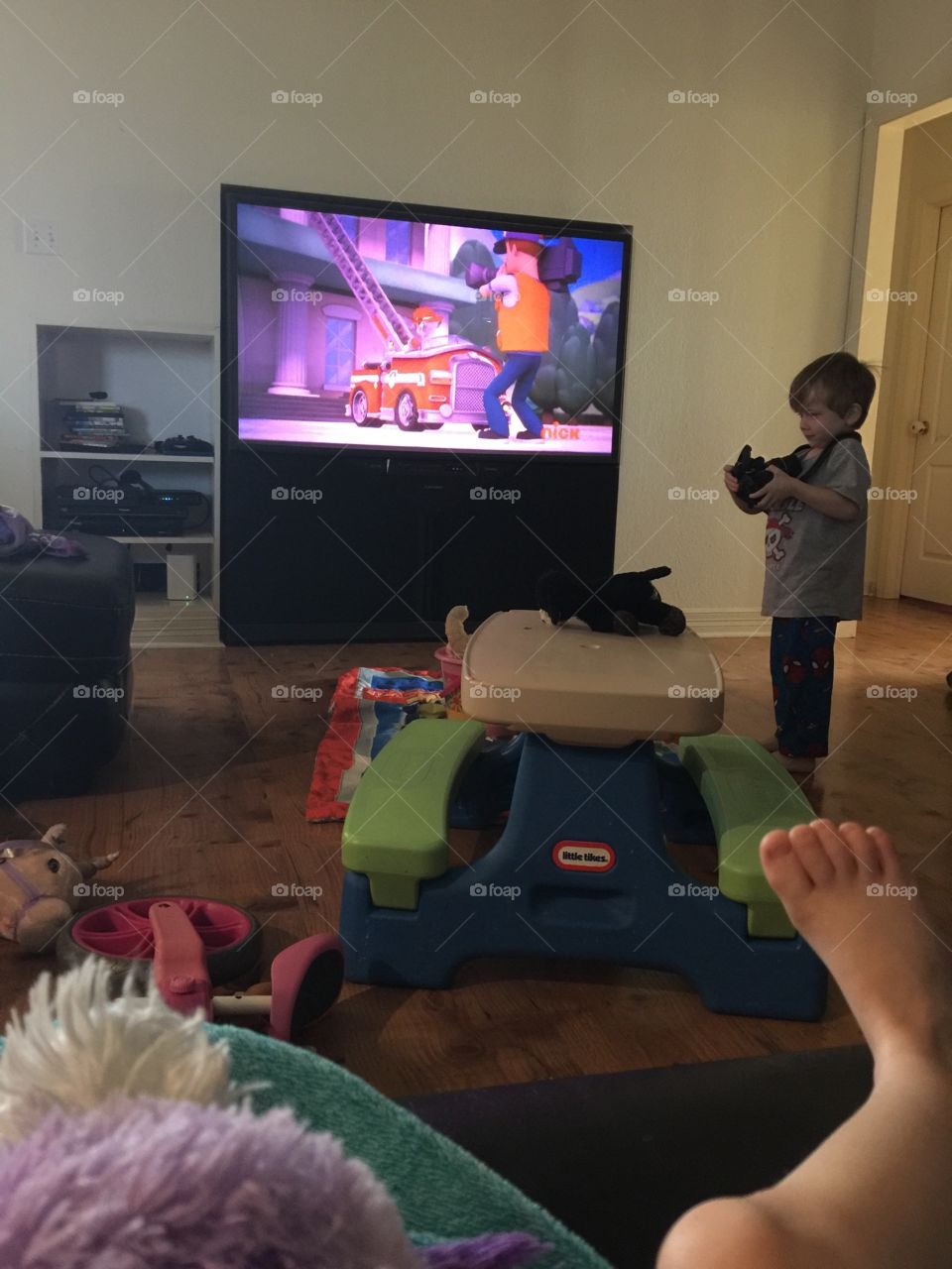 Toddler taking a photo of her brother playing with a camera