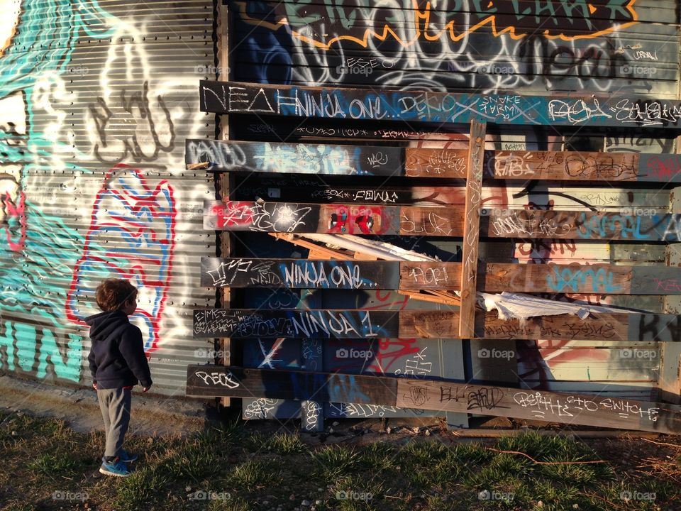 Boy looking at street art