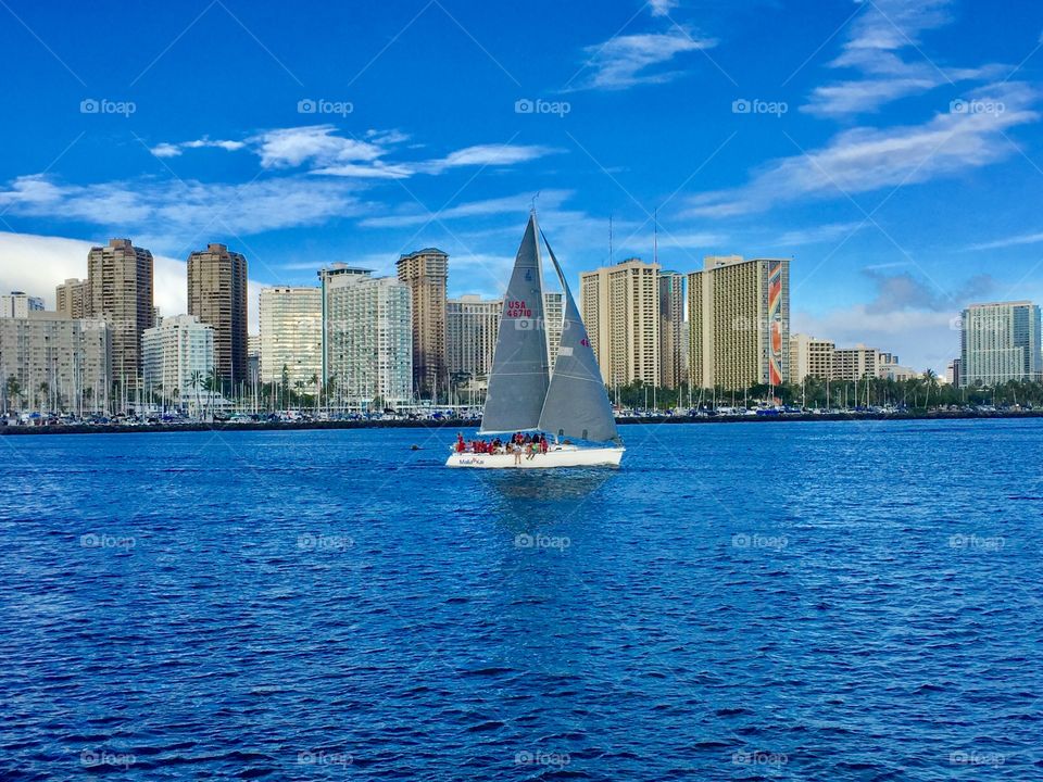 In the background, we can see the amazing city of Honolulu. The boat we can see, looks small but actually it’s really big. It needs space in order to take so many people far in the bay to look at the sunset.