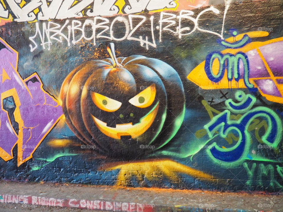 Halloween graffiti of pumpkin in Leake street tunnel in London.