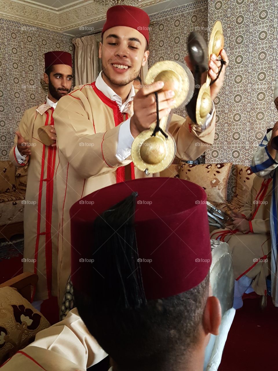 Man in traditional dress playing musical, instrument