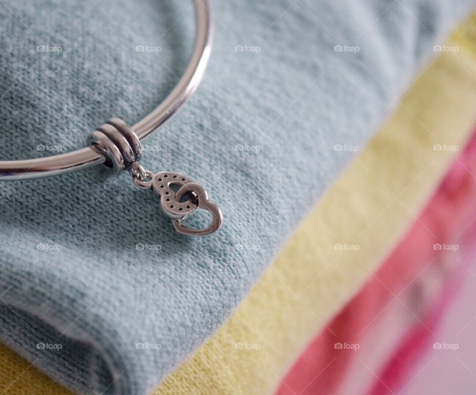 Close-up of bracelet on textile