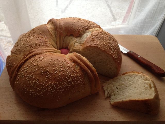 Fresh loaf of bread prepared for Easter with a red egg in the centre 