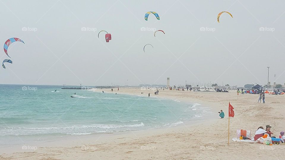 skydivers over the beach