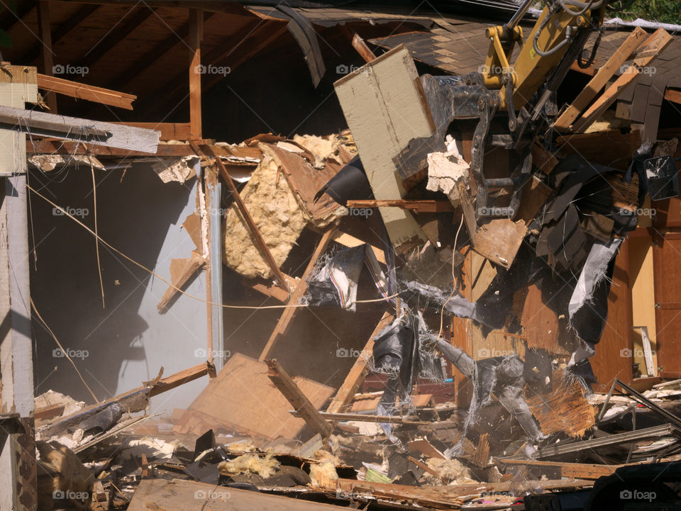 Debris and Wires Strewn across a Storm Damages Home during Demolition Prior to Rebuilding.