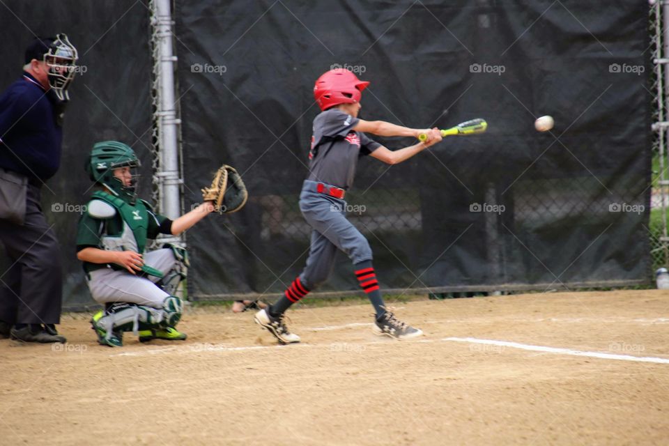 Boy batting in baseball game