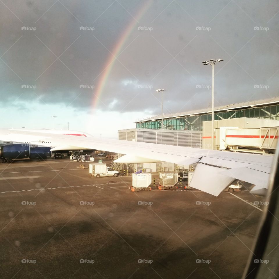 rare picture of a double rainbow captured from inside the plane
